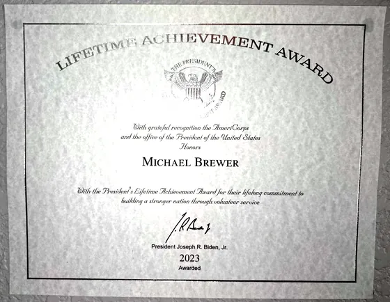 Certificate of the President’s Lifetime Achievement Award honoring Michael Brewer, signed by President Joseph R. Biden, Jr., awarded 2023.